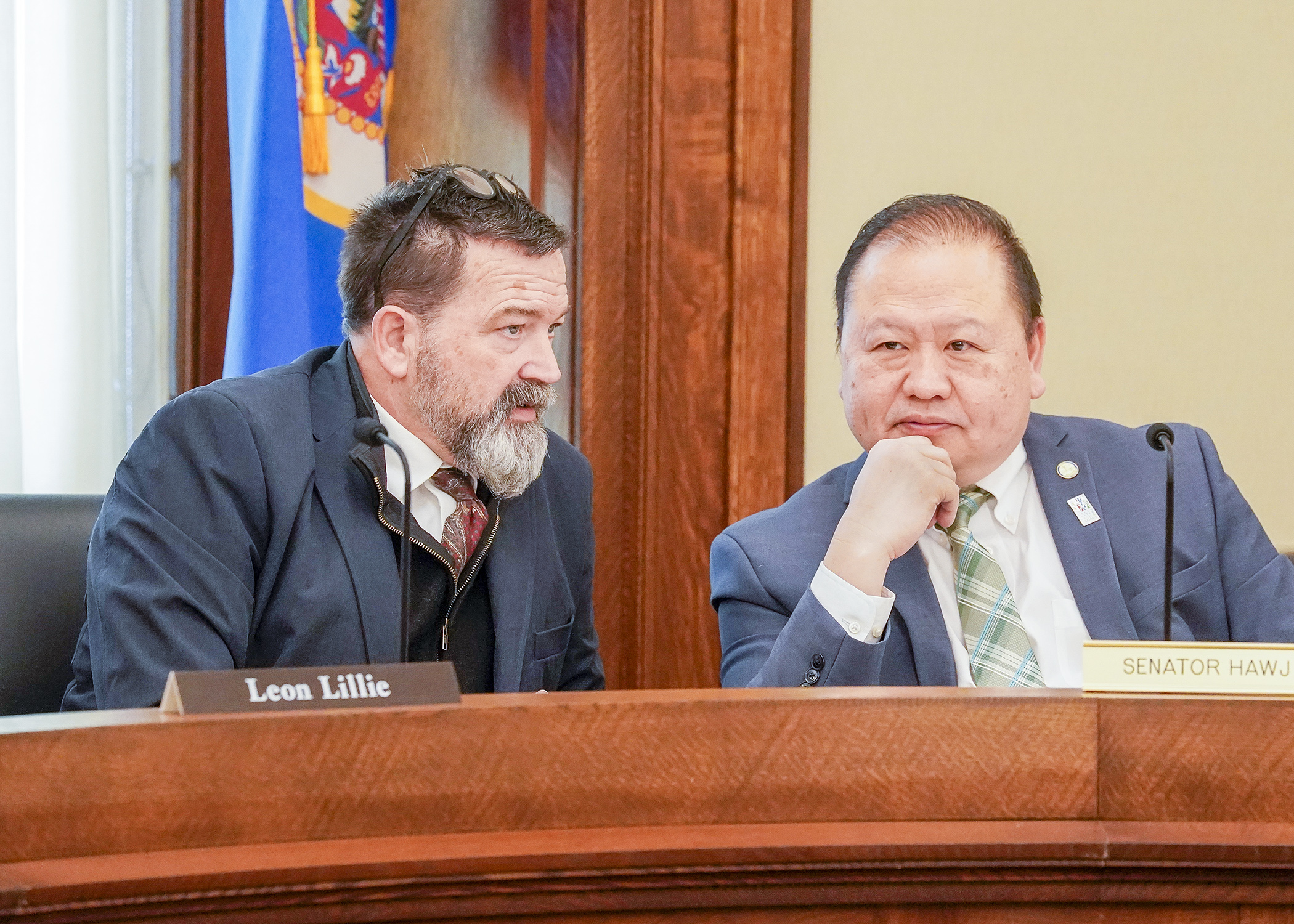 Rep. Leon Lillie and Sen. Foung Hawj confer April 26 prior to the House gaveling in the conference committee on HF1999, the omnibus legacy finance bill. (Photo by Andrew VonBank)